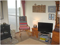 The comfortable sitting room with a wood burner and seaward facing views in Lilburn's Pier